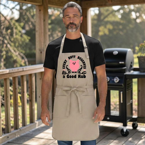 Khaki Port Authority A600 grilling apron with printed design of a pig's butt & grill utensils with the words every butt deserves a good rub